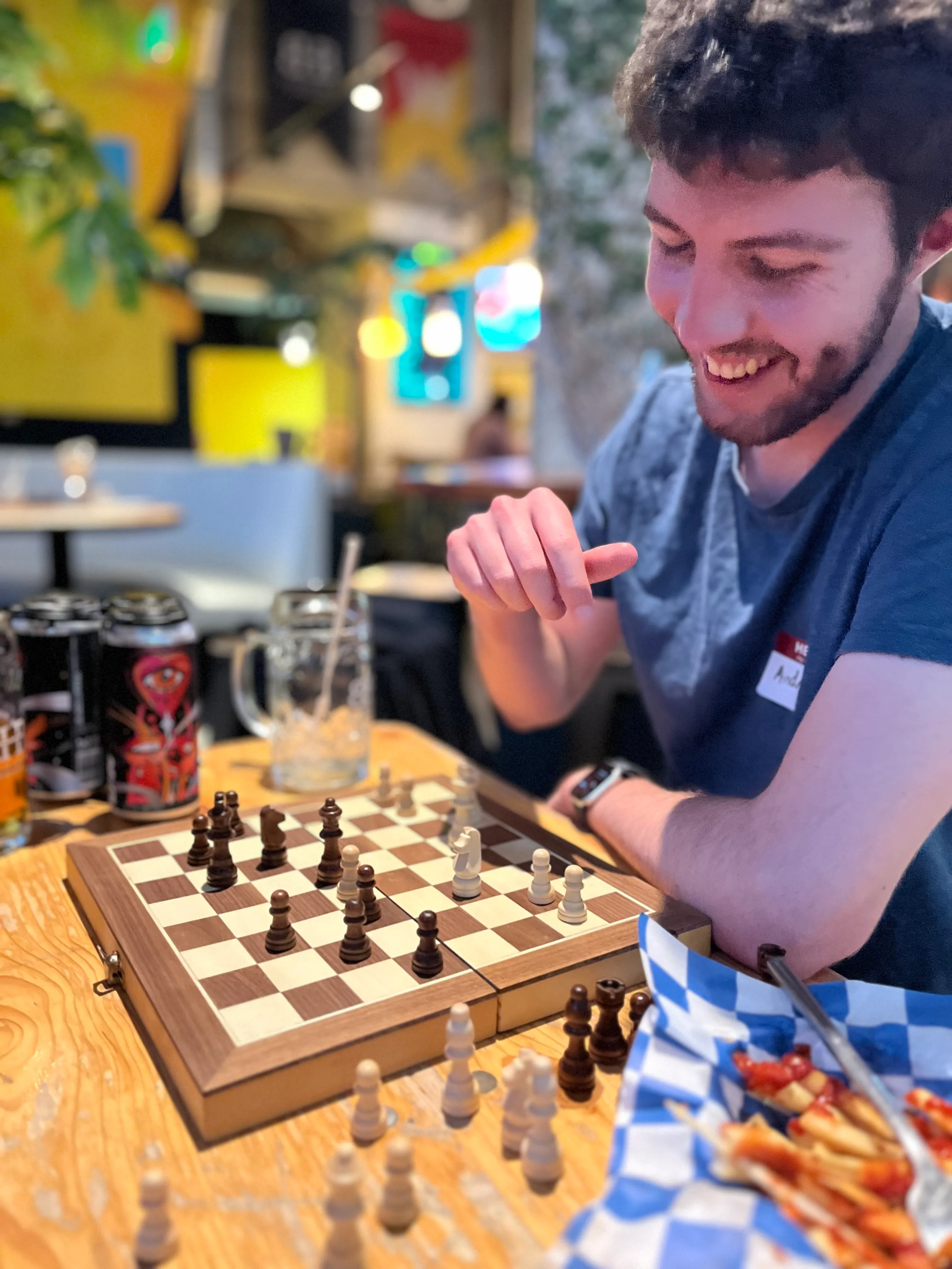 Guy smiling while playing chess